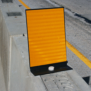 [Image Description: An Easy View Marker mounted on top of a concrete barrier.]