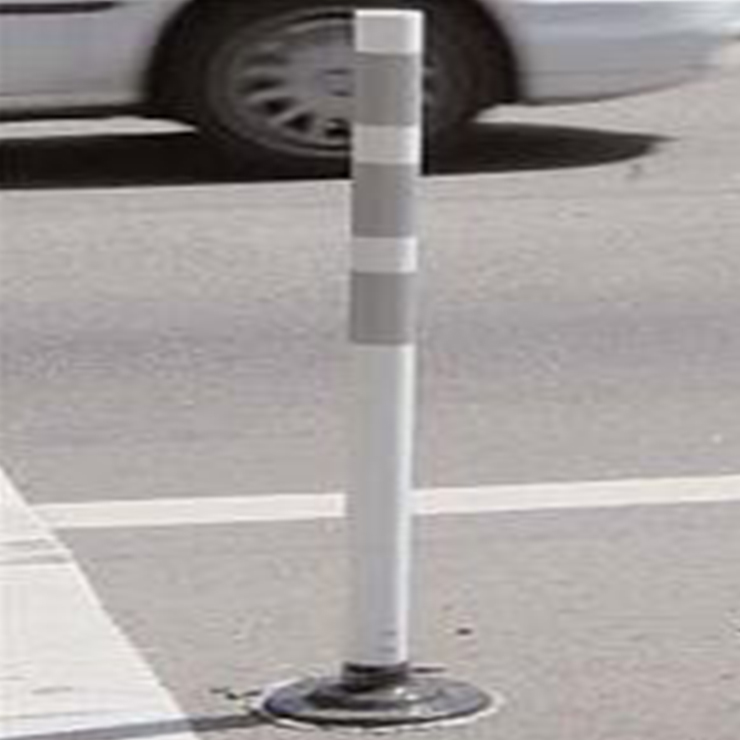[Image Description: A 3 inch wide white cylindrical pole delineator fixed to the surface of a parking lot.]